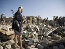 A Houthi Shiite fighter stand guard as people search for survivors under the rubble of houses destroyed by Saudi airstrikes near Sanaa Airport, Yemen A Houthi Shiite fighter stand guard as people search for survivors under the rubble of houses destroyed by Saudi airstrikes near Sanaa Airport, Yemen
