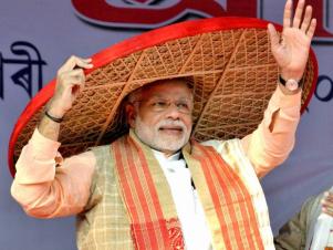 Prime Minister Narendra Modi being presented with a traditional Assamese Japi at the 85th Annual Conference of Srimanta Sankaradeva Sangha in Sivasagar, Assam
