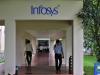 Employees walk along a corridor in the Infosys campus in the southern Indian city of Bangalore