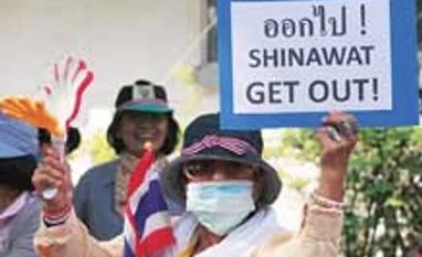 Thai PM calls snap election, protesters press on