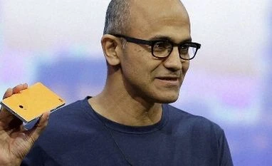 Microsoft chief Nadella to visit India this month Microsoft CEO Satya Nadella holds up the Nokia Lumia 930 phone that uses Windows 8.1 during the keynote address of the Build Conference Wednesday, April 2, 2014, in San Francisco