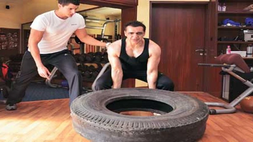 Ajay Bijli attempts the ‘tyre flip’ under the supervision of his personal trainer, Alex Pattrick Ajay Bijli attempts the ‘tyre flip’ under the supervision of his personal trainer, Alex Pattrick