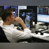World stocks dip amid economic uncertainty, global outage disruptions A broker sits at his desk on the trading floor at BGC Partners in London