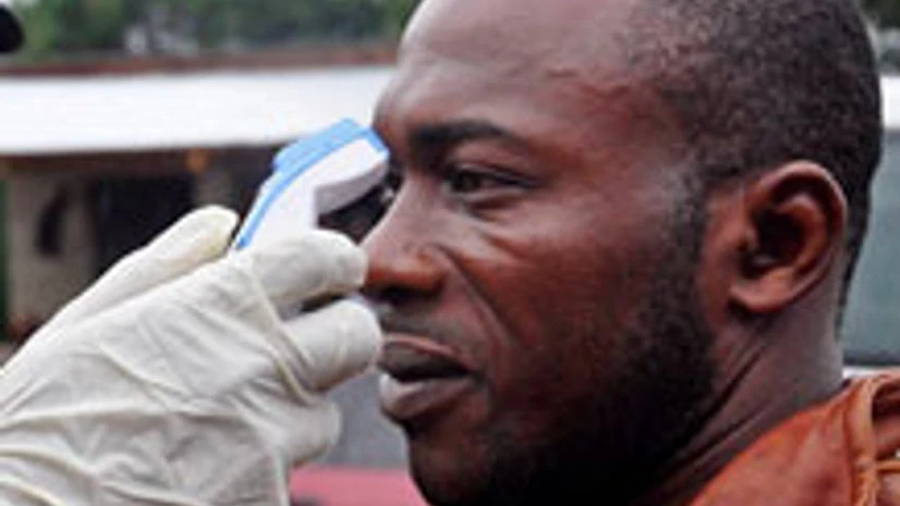 A man's temperature is measured before he is allowed into a business center, as fear of the deadly Ebola virus spreads through the city of Monrovia, Liberia, on August 9, 2014 A man's temperature is measured before he is allowed into a business center, as fear of the deadly Ebola virus spreads through the city of Monrovia, Liberia, on August 9, 2014