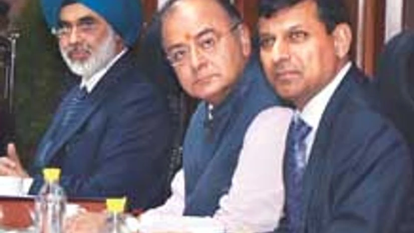 Raghuram Rajan with Arun Jaitley and Financial Services Secretary G S Sandhu Raghuram Rajan with Arun Jaitley and Financial Services Secretary G S Sandhu
