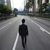 A man walks along an empty street near the central financial district in Hong Kong