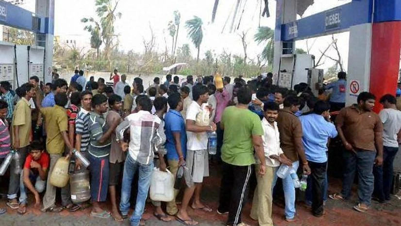 People stand in a long queue to get fuel after Hudhud Cyclone in Vishakapatnam