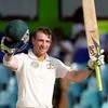 In this file photo, Australian batsman Phillip Hughes celebrates after scoring a century during the fourth days' play of the third cricket test match between Australia and Sri Lanka in Colombo, Sri Lanka.
