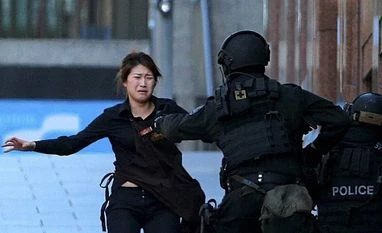 Police storm Sydney cafe, free hostages, two dead