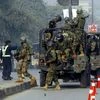 Pakistani army troops arrive to conduct an operation at a school under attack by Taliban gunmen in Peshawar, Pakistan