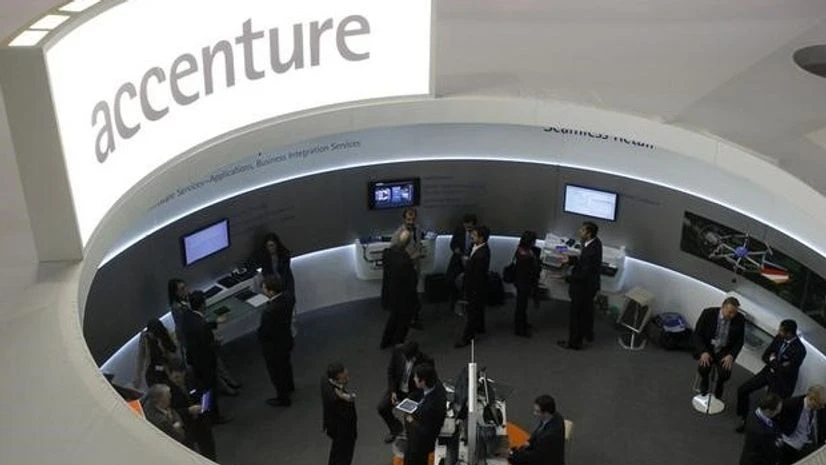 Visitors look at devices at Accenture stand at the Mobile World Congress in Barcelona Visitors look at devices at Accenture stand at the Mobile World Congress in Barcelona