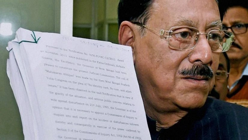 Justice Sushanta Chatterjee displays his commission report on the police firing on July 21, 1993, in which 13 Congress workers were killed and more than 50 people were injured, in Kolkata Justice Sushanta Chatterjee displays his commission report on the police firing on July 21, 1993, in which 13 Congress workers were killed and more than 50 people were injured, in Kolkata