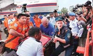 Divers hunt for bodies in crashed AirAsia jet's fuselage