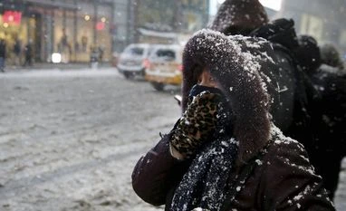 'Snowzilla' paralyses US from Washington to New York A woman looks out from her winter coat in midtown Manhattan in New York