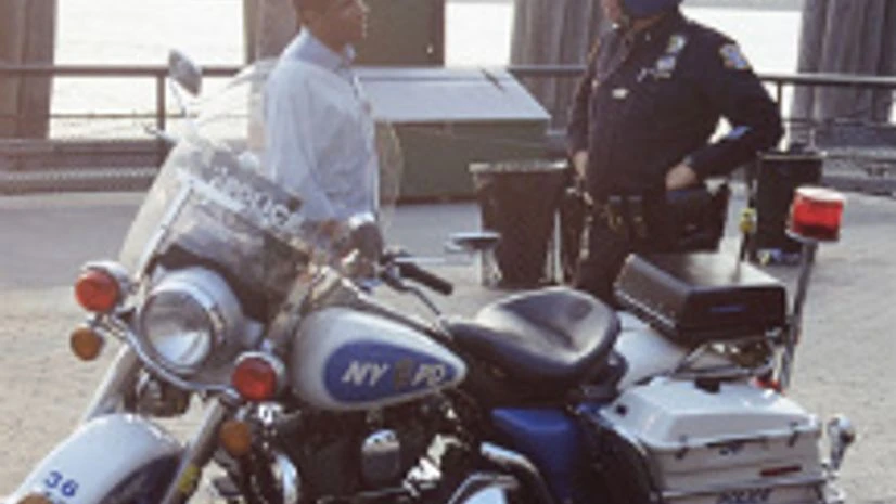 NYPD A NYPD motorcycle police officer speaks with a passerby. Photo credit: Wikipedia