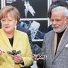 German Chancellor Angela Merkel (left) and Indian Prime Minister Narendra Modi hold BionicANTs  at the world's largest industrial technology fair, the Hannover Messe, in Hanover