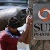 A man carrying a gas cylinder walks out of the research and development centre of Sun Pharmaceutical Industries Ltd in Mumbai