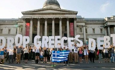 Will Greece crisis balloon out of proportion? No, it's different this time (File Photo) Demonstrators holding letters to form a banner take part in a protest against the European Central Bank, in Trafalgar Square, London, over Greece's debt repayments in 2015