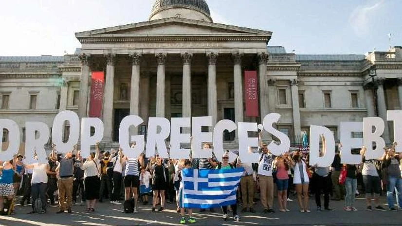 (File Photo) Demonstrators holding letters to form a banner take part in a protest against the European Central Bank, in Trafalgar Square, London, over Greece's debt repayments in 2015 (File Photo) Demonstrators holding letters to form a banner take part in a protest against the European Central Bank, in Trafalgar Square, London, over Greece's debt repayments in 2015
