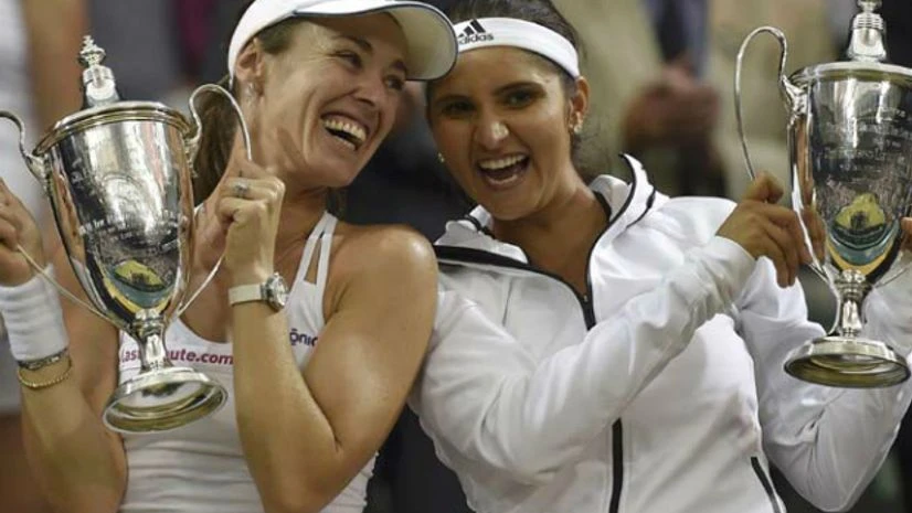 Sania Mirza Sania Mirza and Martina Hingis posing with the Wimbledon women's doubles trophy. Th epair beat Ekaterina Makarova-Elena Vesnina 5-7 7-6(4) 7-5 in the finals. Picture: Reuters