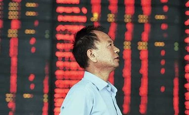 Operation to steady China stocks a success, but thin volumes raise questions An investor stands at a brokerage house, near an electronic board filled with red figures indicating rising prices, in Fuyang, China on Tuesday