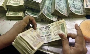 FinMin to decide on borrowing programme for Oct-Mar on Sep 28 An employee counts currency notes at a cash counter inside a bank in Kolkata