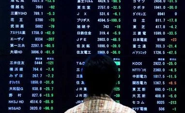 Asian shares pressured by fears over Delta virus variant, US data in focus A woman stands in front of a display showing market indices at the Tokyo Stock Exchange