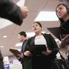 US nonfarm payrolls increase solidly, wages rebound