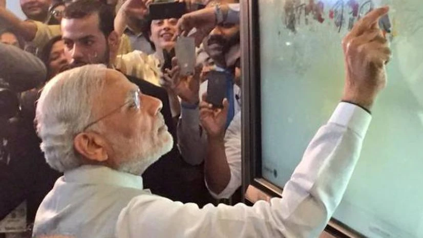 PM Narendra Modi digitally signs the message "Science is life" in the visitors book at Masdar City
