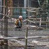A labourer works on the construction site of a residential building in Mumba