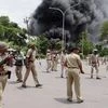 Police personnel in action as Patel community supporters go on rampage in Surat on Wednesday. Patel community is agitating for OBC status