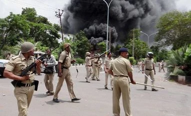 Gujarat flares up under Patidar ire, Army steps in Police personnel in action as Patel community supporters go on rampage in Surat on Wednesday. Patel community is agitating for OBC status