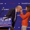 Republican presidential candidate Donald Trump has a supporter, Mary Margaret Bannister, check to see if his hair is real during his speech to supporters during a rally at the TD Convention Center, in Greenville, S.C