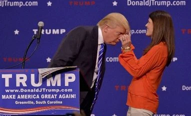 Surging Trump takes a hair test to prove he is real Republican presidential candidate Donald Trump has a supporter, Mary Margaret Bannister, check to see if his hair is real during his speech to supporters during a rally at the TD Convention Center, in Greenville, S.C