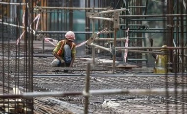 RPP Infra in JV with China's HUNAN for large infra projects A labourer works on the construction site of a residential building in Mumbai