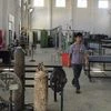 A worker walks inside a factory producing rubber car components in Ninghai, Zhejiang province