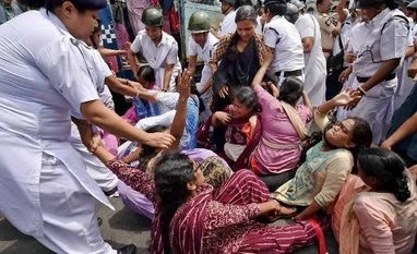 Curfew relaxed in Churachandpur, toll in violence climbs to 8 Police detain SUCI women activists blocking a street during the nationwide strike of Trade Union workers to protest against alleged anti-labour policies of the Central government, in Kolkata