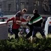 A Syrian man carrying a child (left) scuffles with a Hungarian nationalist in front of the Keleti train station in Budapest, Serbia on Friday (September 4, 2015). Minor skirmishes broke out at the Keleti train station, where hundreds of migrants and