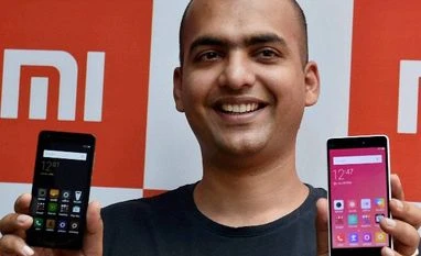 Xiaomi to replicate its just-in-time model in India Xiaomi's India head Manu Jain displays the new phones during a launching event, in Kolkata
