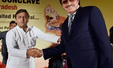 BJP attacks Akhilesh Yadav over Mumbai investors' meet Uttar Pradesh Chief Minister Akhilesh Yadav shakes hands with Bollywood producer-director Sanjay Khan during the Investors Conclave in Mumbai