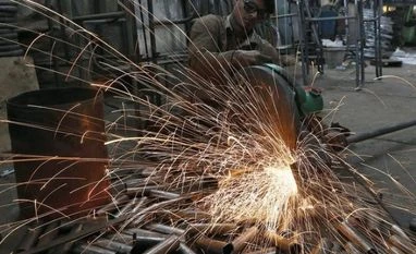 Value of capital goods may reduce IIP volatility A worker cuts a metal pipe inside a steel furniture production factory in Ahmedabad