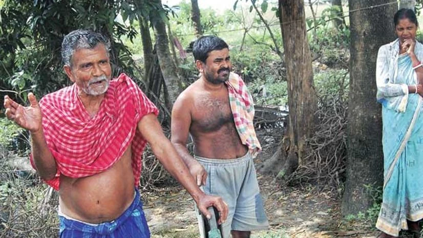 Joydeb Das (left), an 'unwilling farmer', with his family Joydeb Das (left), an 'unwilling farmer', with his family