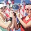 Martina Hingis (left) and Sania Mirza with their trophy after winning the women's doubles championship match of the US Open tennis tournament on Sunday