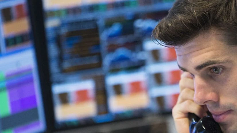 A trader at the trading floor of KBC bank gives a phone call in Brussels, Belgium A trader at the trading floor of KBC bank gives a phone call in Brussels, Belgium
