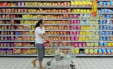 China October CPI shows deflationary pressure persists A customer pushes a cart at a supermarket in Fuyang, Anhui province