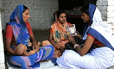 TiE Global to launch entrepreneurship training for women in small towns A health worker using Mobile Kunji card to guide a mother