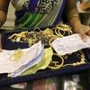 A saleswoman checks the weight and quality of gold jewellery inside a showroom in Mumbai