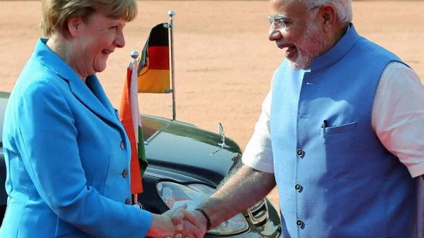 Prime Minister Narendra Modi welcomes German Chancellor Angela Merkel as she arrived for the ceremonial reception at the forecourt of Rashtrapati Bhawan in New Delhi on Monday Angela Merkel, Narendra Modi