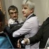 Air France director of Human Ressources, Xavier Broseta, center left, and Air France assistant director long-haul flight, Pierre Plissonnier, center right, are protected by Air France security guards during scuffles with union activists inside the Ai