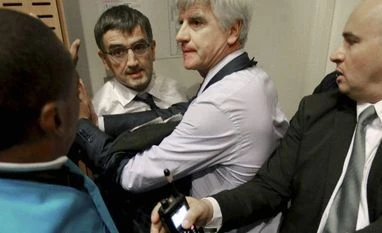 Air France managers flee as staff storm meeting on job cuts Air France director of Human Ressources, Xavier Broseta, center left, and Air France assistant director long-haul flight, Pierre Plissonnier, center right, are protected by Air France security guards during scuffles with union activists inside the Ai